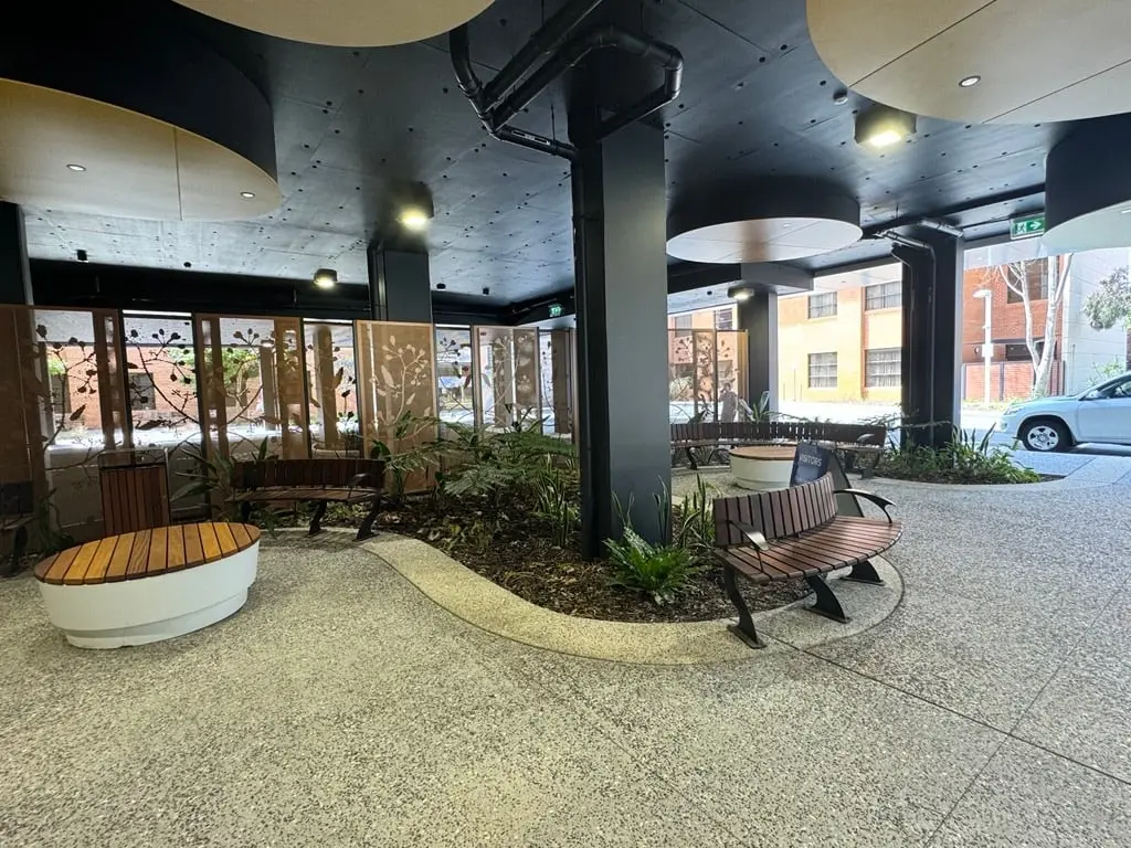 Exposed aggregate forecourt with a curved pale edge band at Hollywood Private Hospital