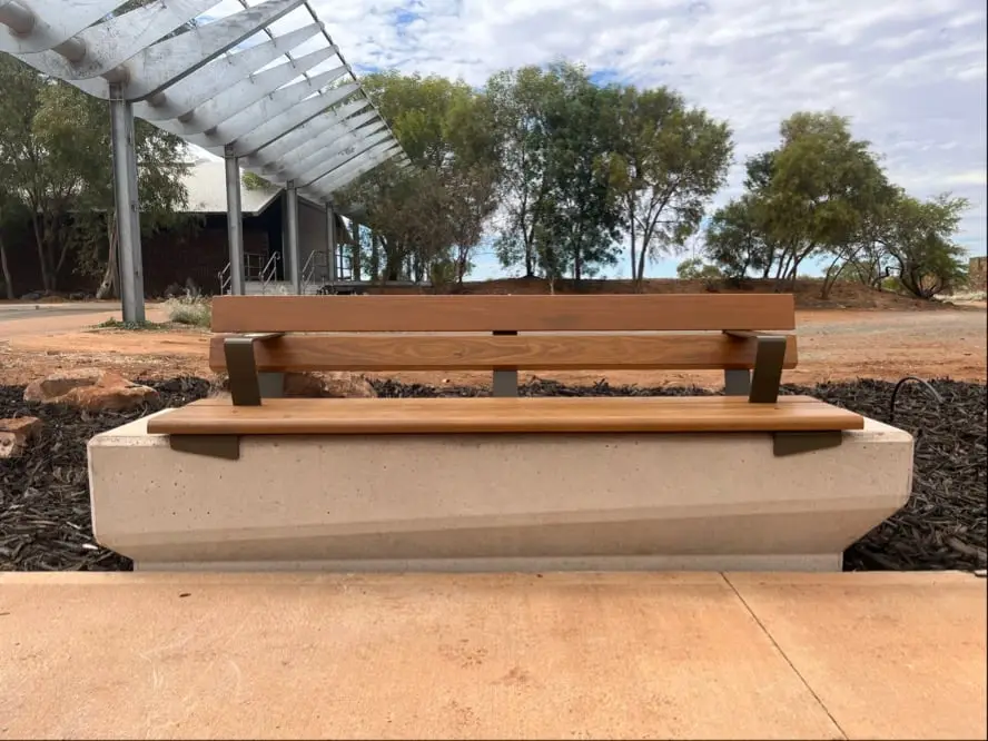 Precast coloured concrete seating plinth with a hardwood bench top