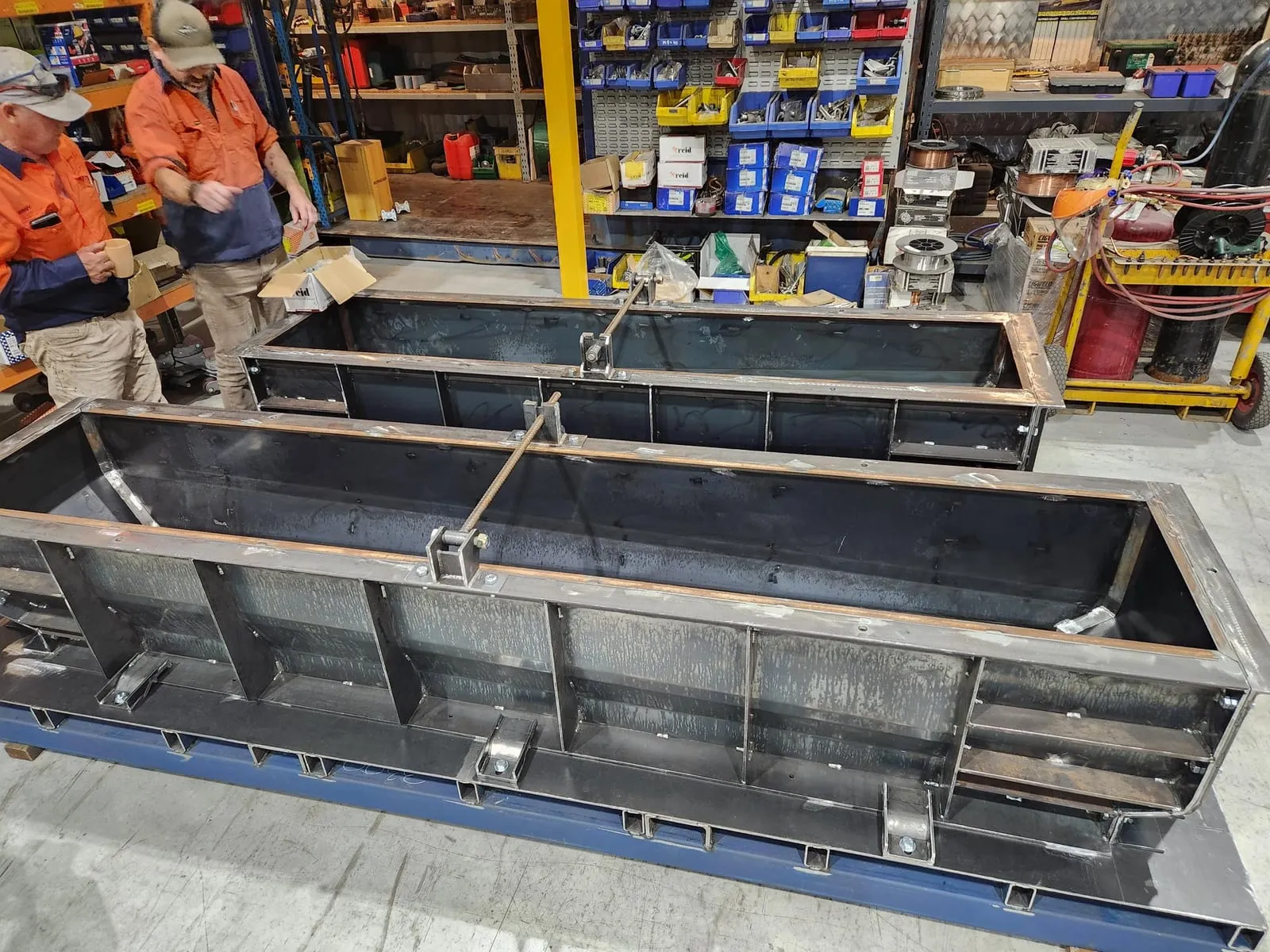 Steel moulds for the seating plinths set up in a fabrication workshop, ready to cast