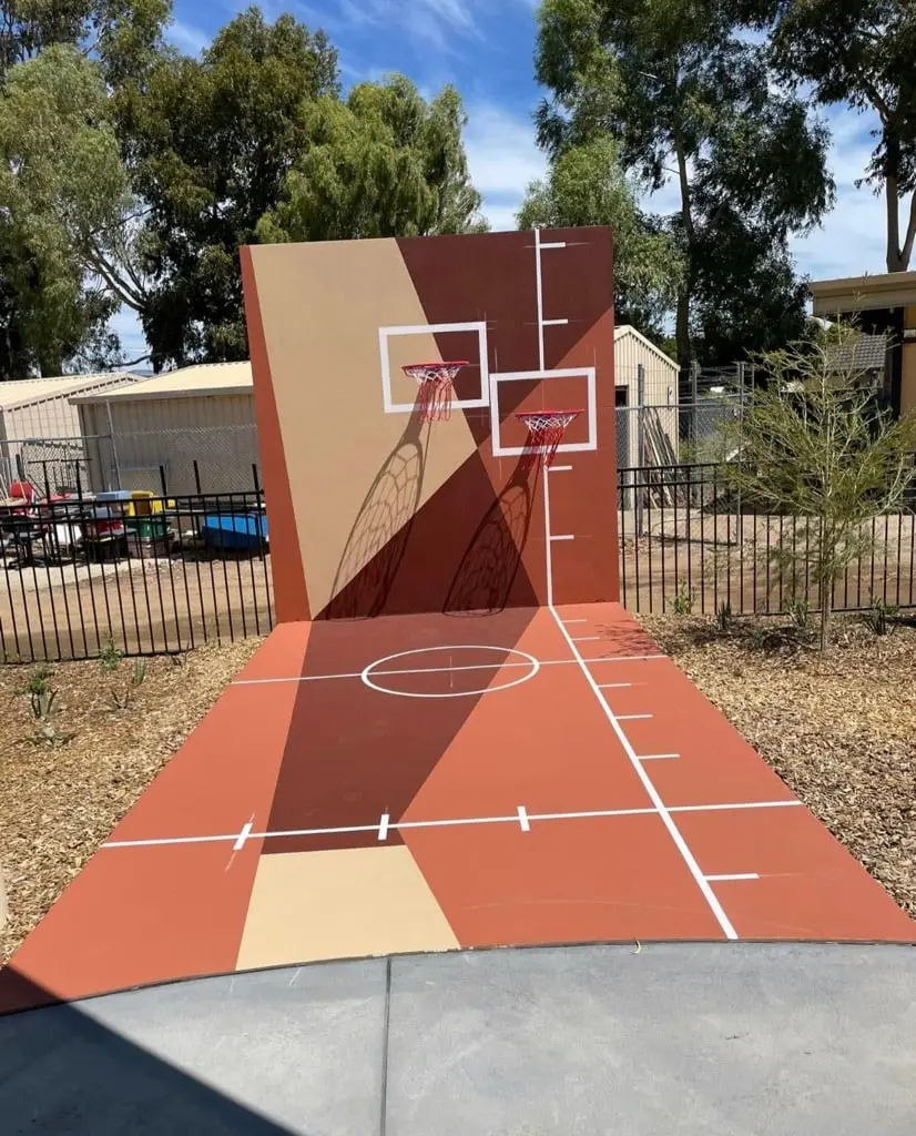 Concrete half court and backboard wall finished flat for a painted sports surface at St Brigid’s Primary School