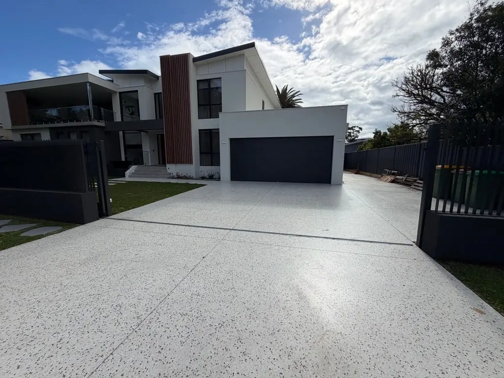Mont Blanc honed driveway with saw-cut joints to a double garage
