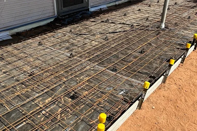 SL72 mesh on bar chairs over the membrane, formwork set and ready for the pour