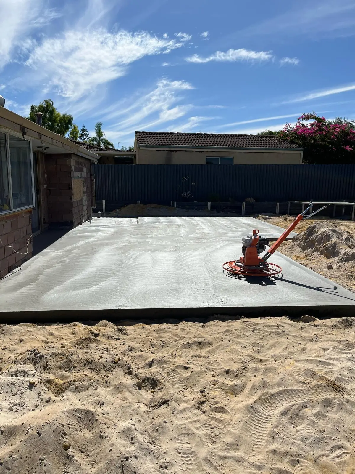 Grey slab being power trowelled flat